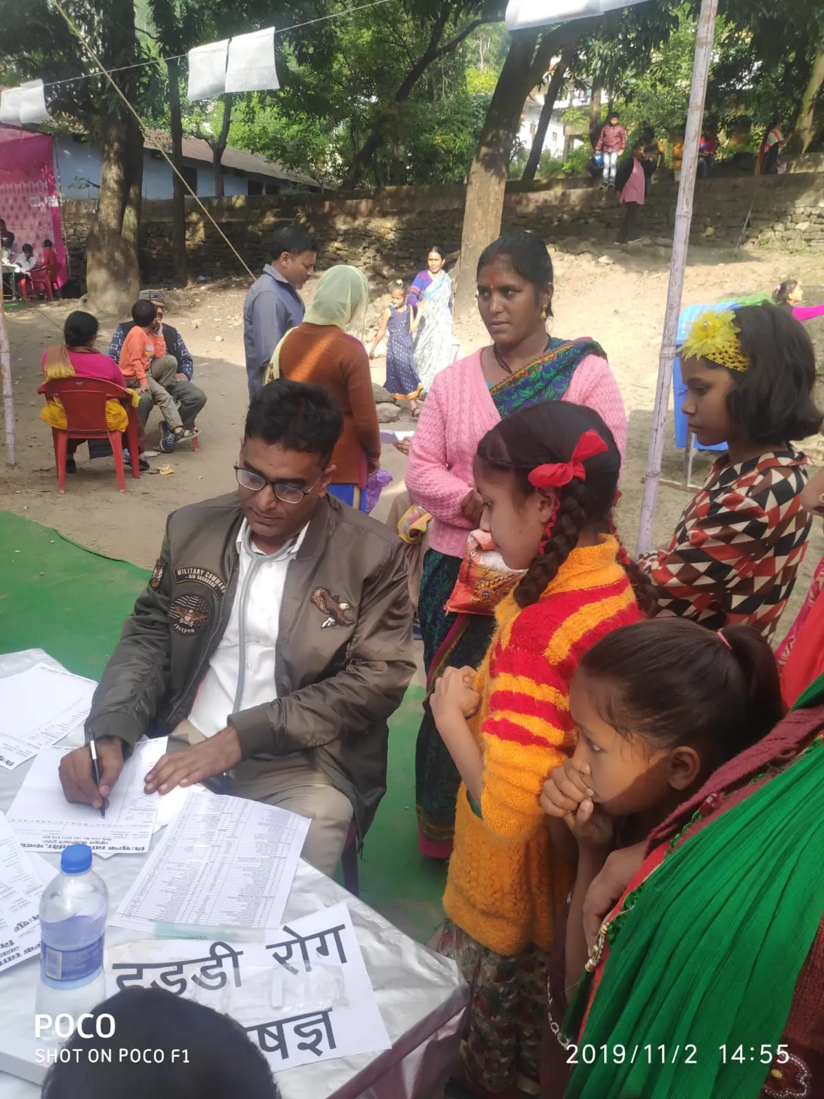 Dr. Rajiv Singh speaking with families at a community medical camp