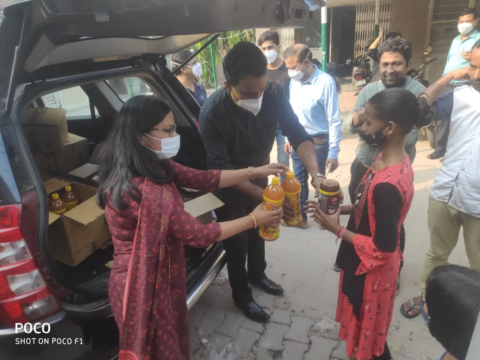 Essential supplies being handed to a child during community outreach.